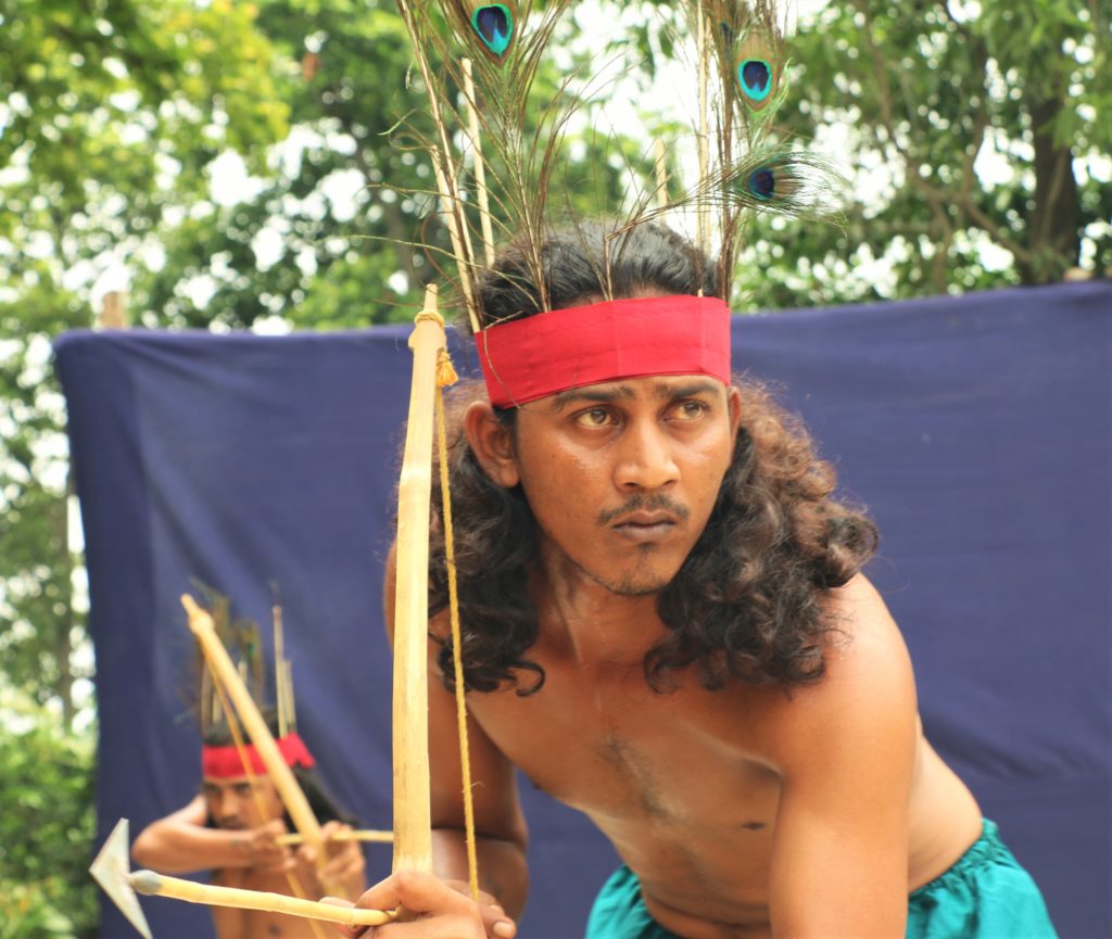 A tribal theatre actor enacting a hunting scene in the Tepantar theatre village