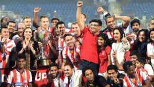 Atletico de Kolkata players and management team celebrate with the ISL trophy in 2014. Picture:PTI