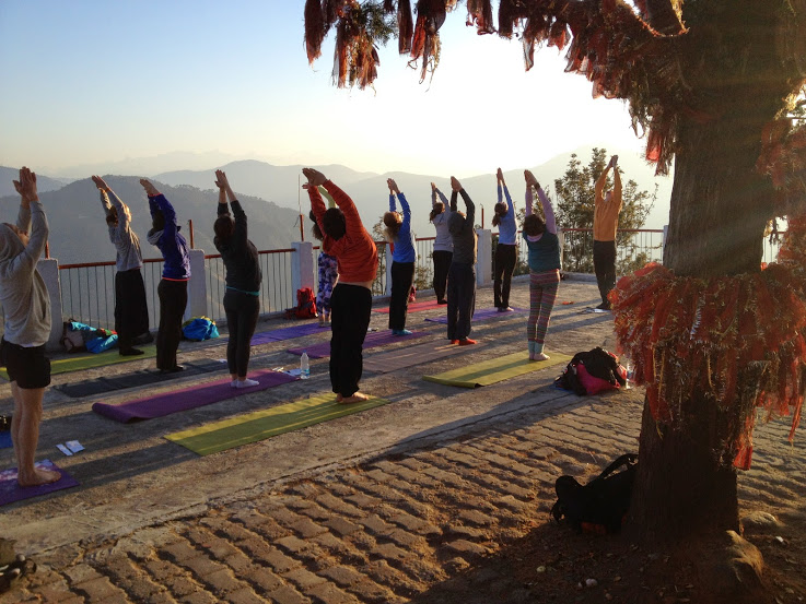 Participants performing special early morning yoga session in the International Yoga and Music Festival at the Kunajapuri Temple, Uttarakhand