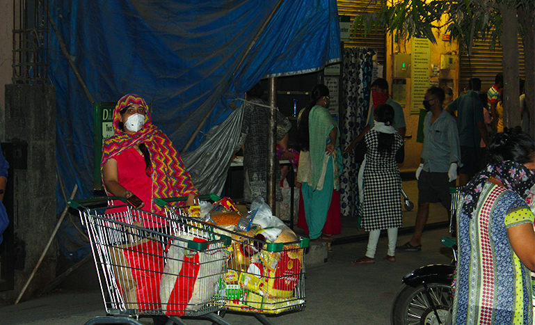A resident of Thane district has her cart filled with loads of supplies