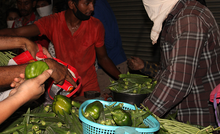 Vegetable vendors trying to manage the crowd